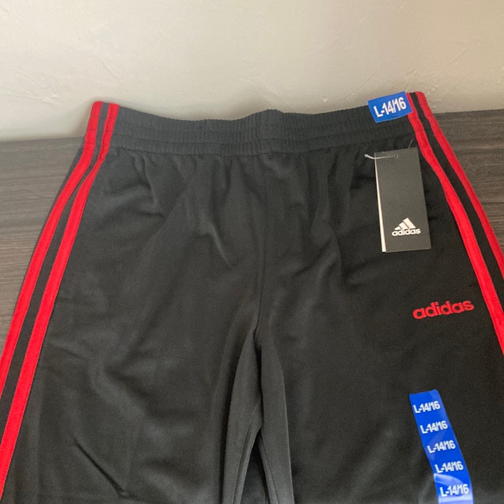 Black and red adidas active wear pants. Size L or 14/16